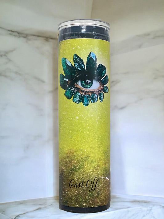 Candle with eye design and 'Cast Off' text on a marble background