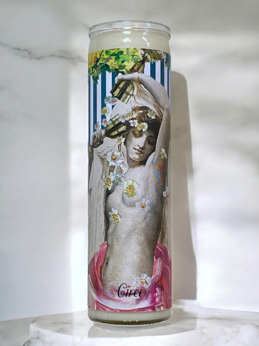 Decorative candle with artistic design of a goddess on a white surface