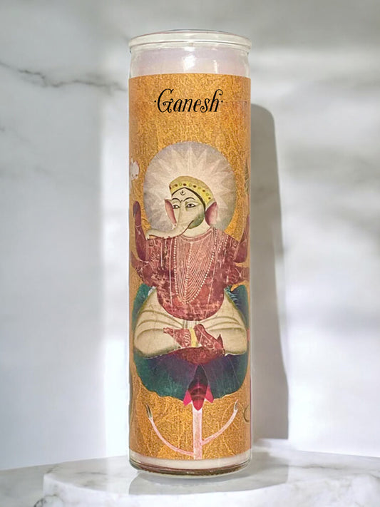 Candle with Ganesh illustration on a marble surface