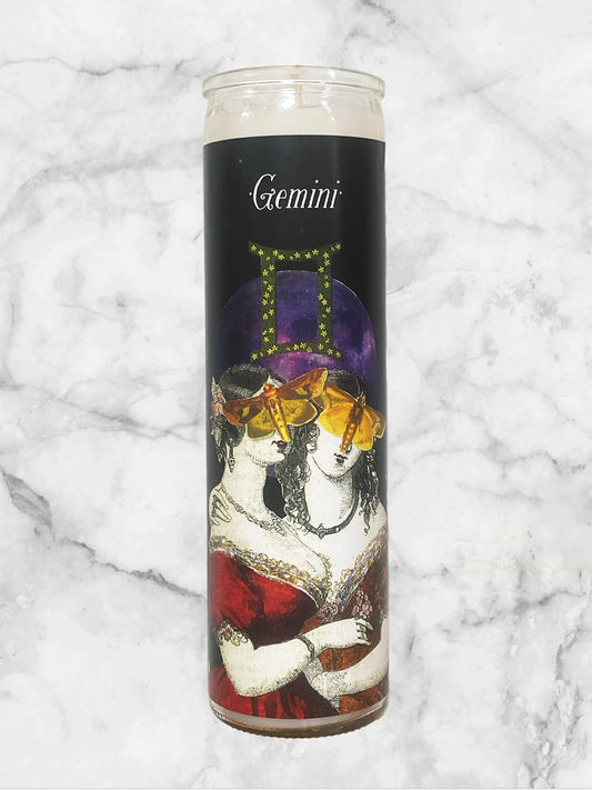 Candle with Gemini zodiac design on a marble background