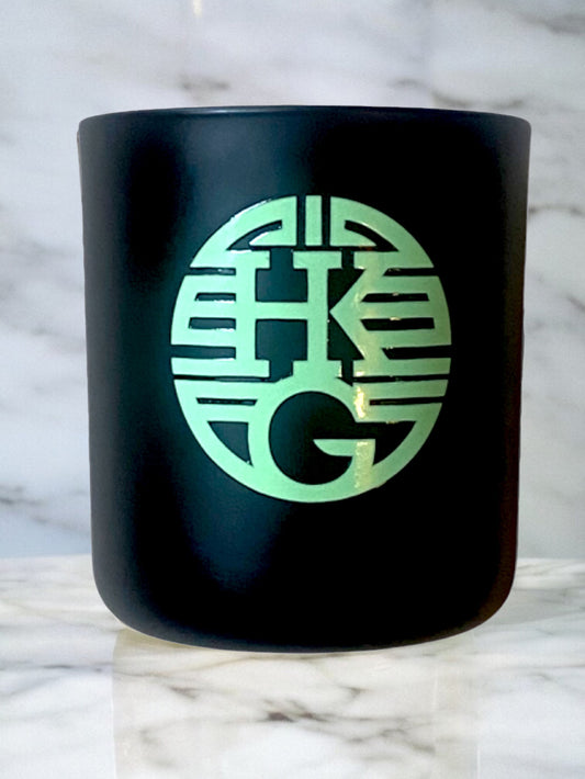 Black container with a green logo on a marble background