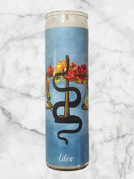 Candle with Libra zodiac design on a marble background