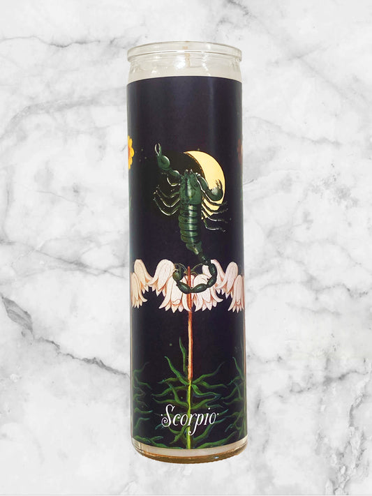 Candle with Scorpio zodiac design on a marble background