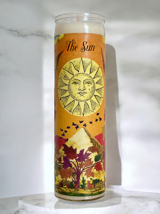 Candle with 'The Sun' design on an orange background