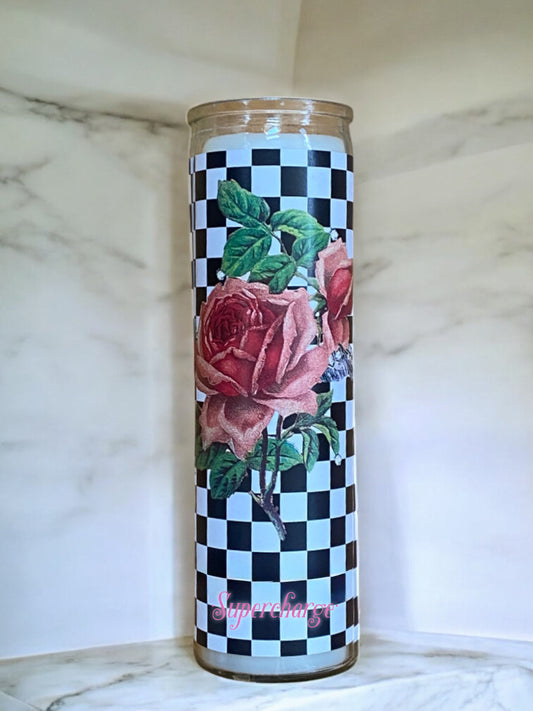 Decorative candle with roses and checkered pattern on a marble surface
