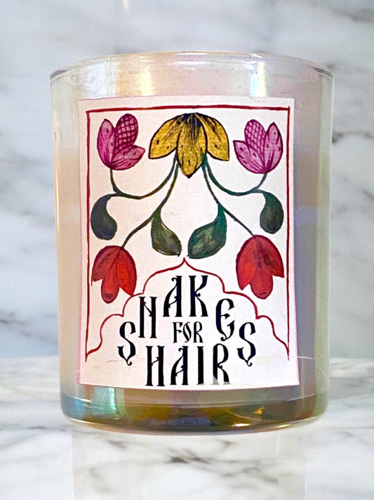 Candle with floral label on a marble surface