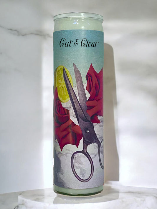 Candle with artistic design of scissors and roses on a light background