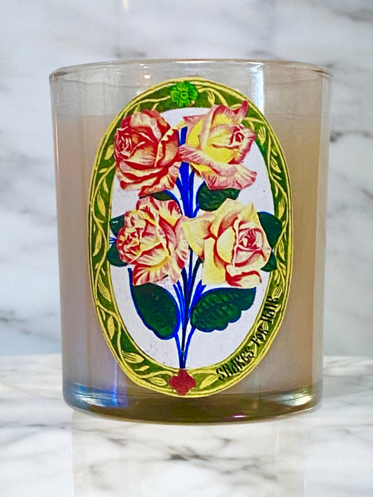Glass tumbler with floral design on a marble surface.